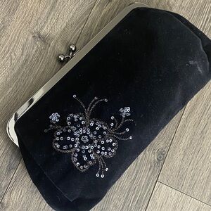 Express black velvet clutch featuring a sequin floral, Gun metal Hardware. Sexy